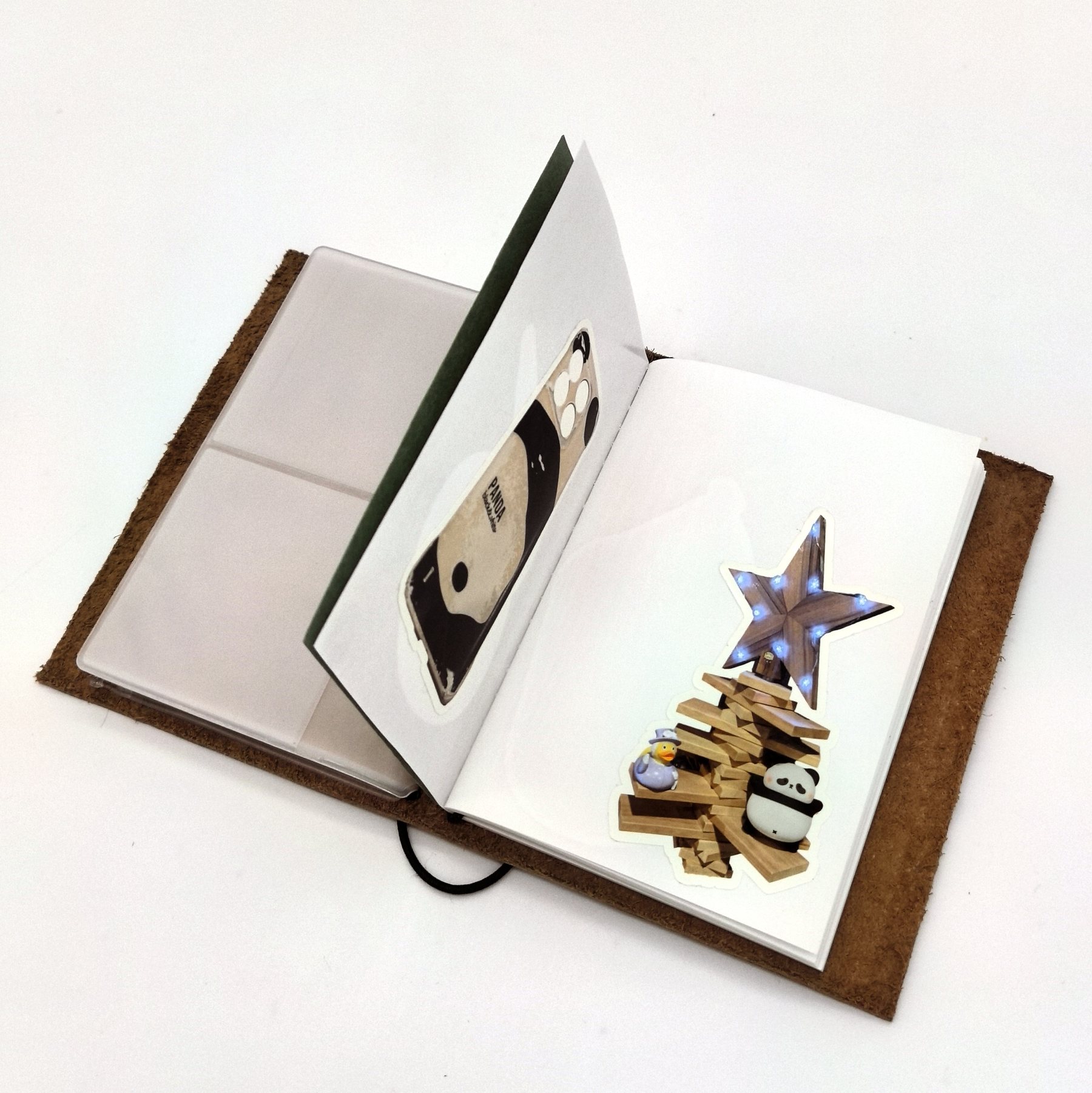 Open traveler's notebook with plastic pocket accessory and page inserts