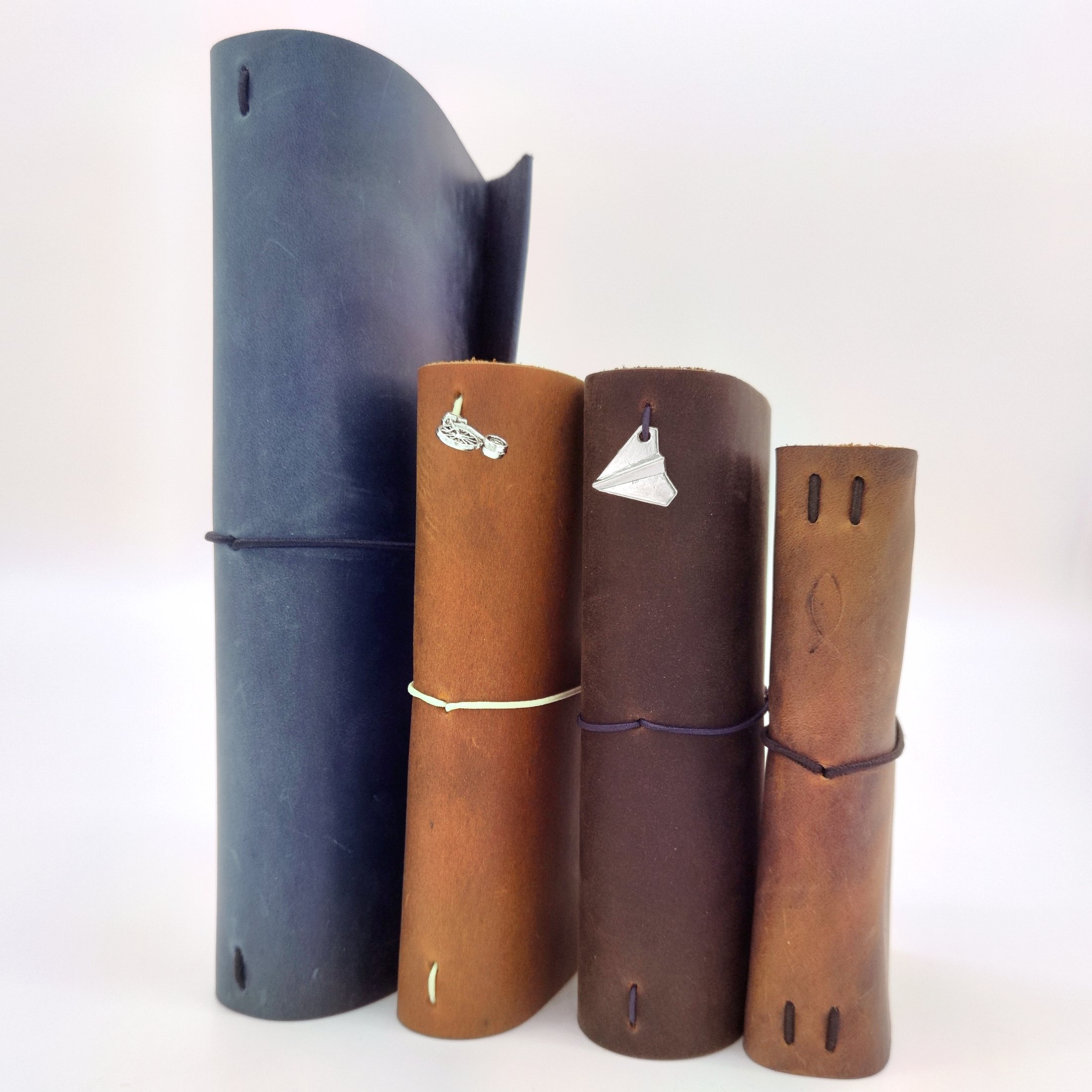 Handmade leather traveler's notebooks in four sizes